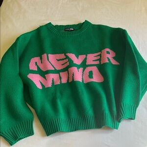 Green Sweater with Pink 'Never Mind' Text